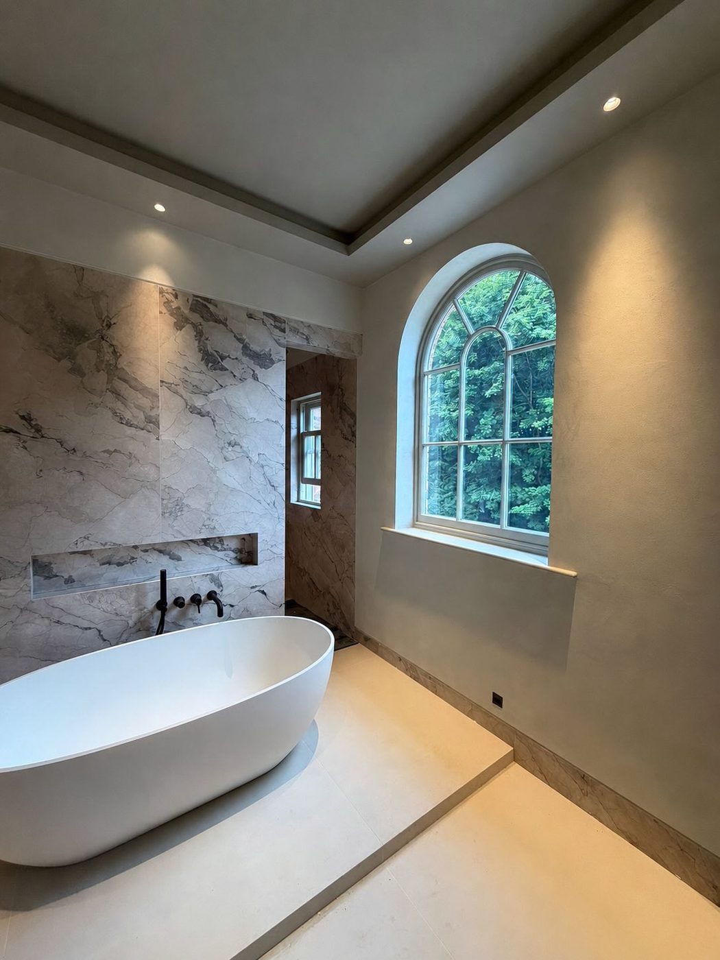 Plaster against marble, arched window