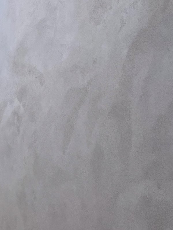 Polished plaster with soft cloudy movement in a pale warm grey